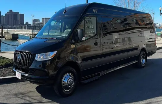 Black Mercedes-Benz Executive Sprinter Van parked near a waterfront for luxury group transportation