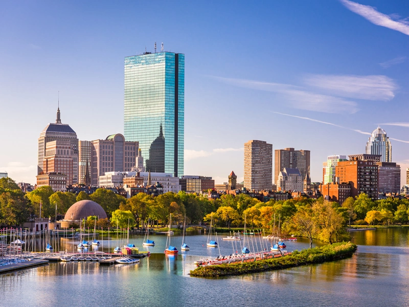 Boston skyline with sailboats on the Charles River at sunset. Boston skyline with sailboats on the Charles River at sunset.