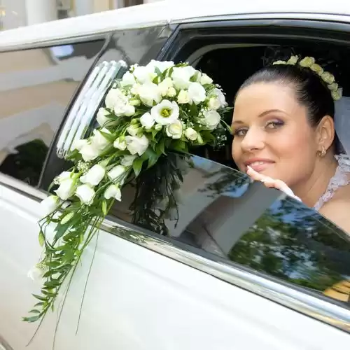 Bride seated inside a white Manhattan wedding limousine