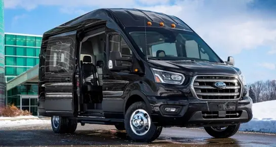 Front view of a professional Ford Transit passenger van for group shuttle and livery services