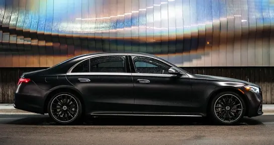 Full side profile of a luxury Mercedes-Benz S-Class parked for professional chauffeur service
