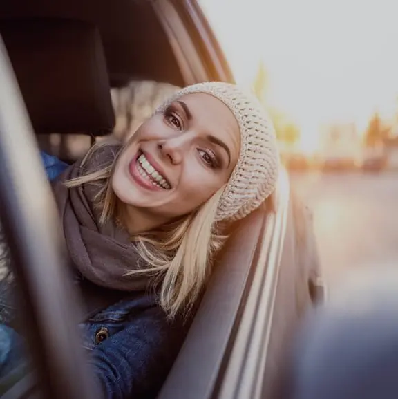 Happy passenger leaning out car window during manhattan car service