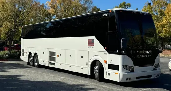 Large white Prevost Motor Coach for high-capacity group travel, corporate events, and long-distance charters