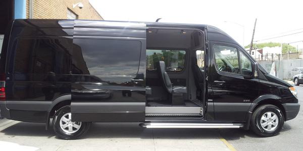 Luxurious black Mercedes Sprinter van rental in Manhattan with open sliding door