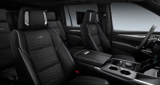Luxury Cadillac Escalade cockpit featuring quilted leather seats and advanced curved OLED display