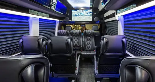 Premium executive van interior with reclining leather captain's chairs and spacious legroom for passengers