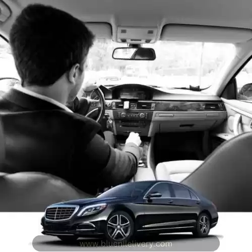 Professional chauffeur inside a premium black car Professional chauffeur inside a premium black car