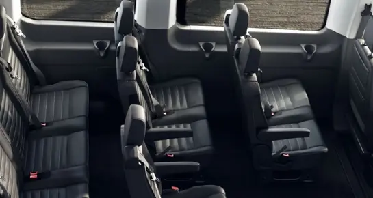 Rear view of a high-roof Ford Transit shuttle van showing wide entry doors for easy passenger boarding