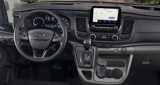 Side view of a black Ford Transit passenger van showing the driver’s cockpit, steering wheel, and dashboard