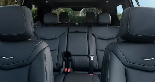 Spacious leather rear seating in a luxury Cadillac SUV for executive passenger comfort