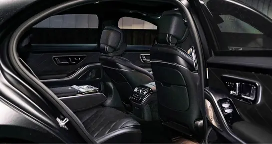 Spacious rear cabin of a Mercedes-Benz S-Class highlighting executive legroom and luxury interior finishes